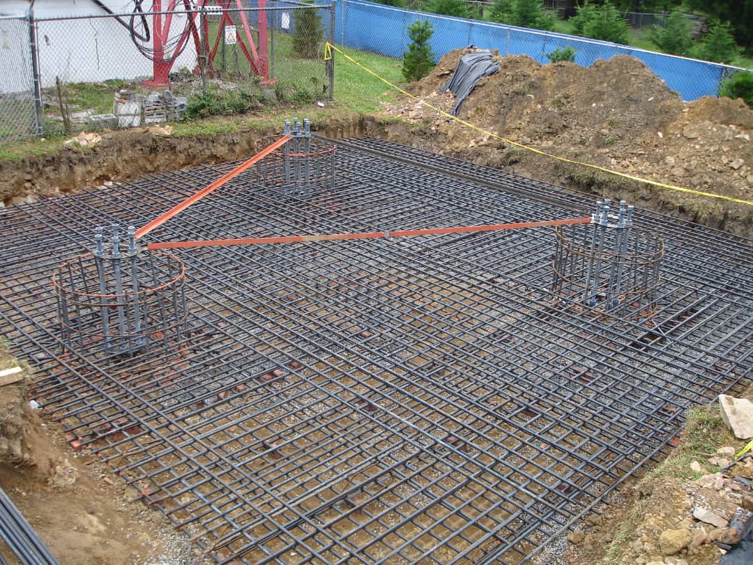 Steel reinforcement mesh and tower anchor bolt cages prepared in an excavated tower foundation