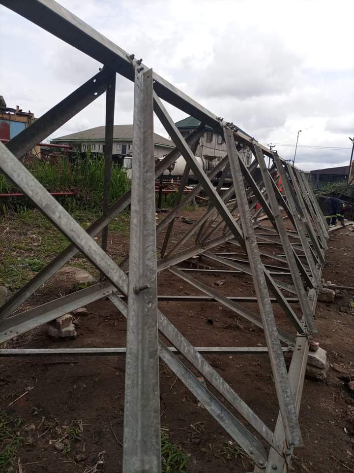 Galvanised steel lattice tower section lying on the ground ready for assembly